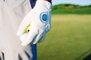 Closeup On Man's Golf Glove With Palmilla Beach Resort Logo Holding A Couple Of Golf Balls