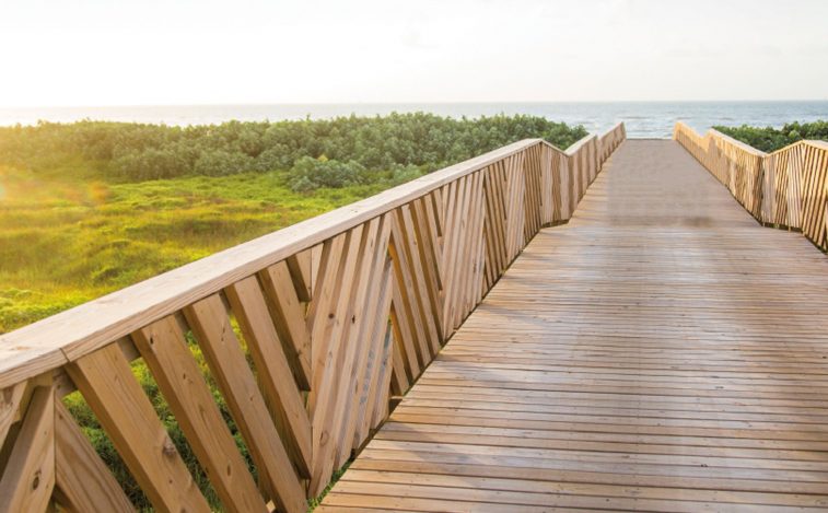 The Inspiration for Waters Edge featuring the wooden dunes crossover bridge leading to the beach in Port Aransas