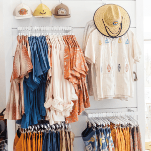 Coastal Closet Clothing Merchandise Hanging From Wall