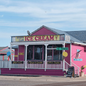 Desserted Island Ice Cream shop stands tall and pink in Port Aransas, Texas