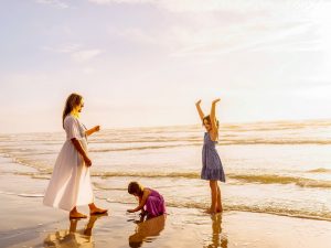 Mother And Children Enjoying The Beach