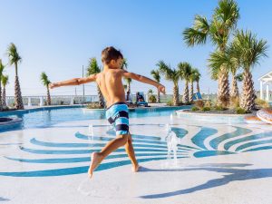 Boy Enjoying Splash Pad At Palmilla Beach