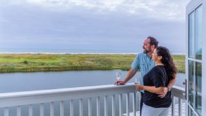Couple Enjoying Balcony Of 600 Sunset Avenue