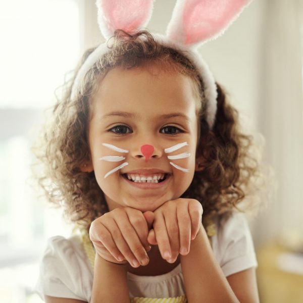 Home, portrait and girl with creative for bunny ears, decoration and costume for cosplay with child. Happy kid, face paint and playful art for tradition, festive celebration and easter with acting.